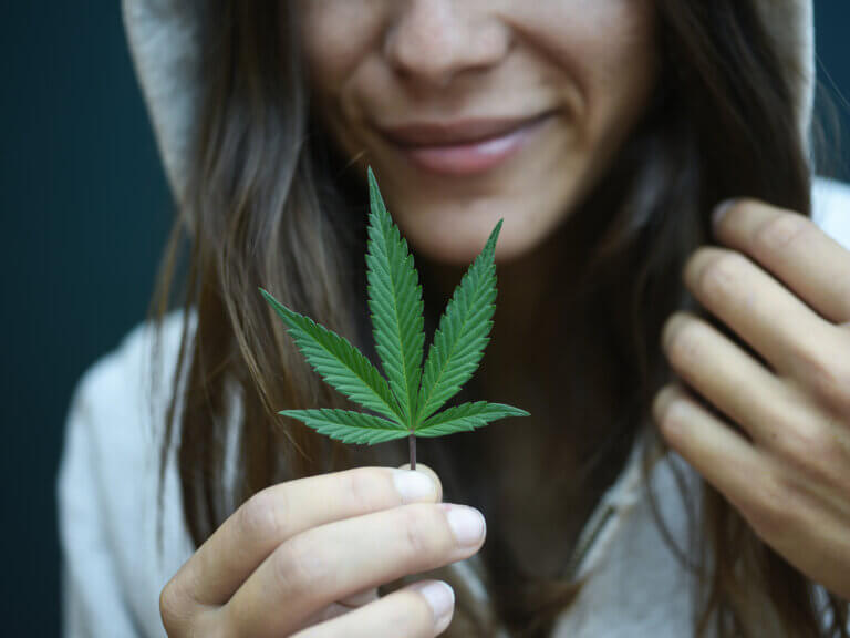 hooded girl with marijuana leaf