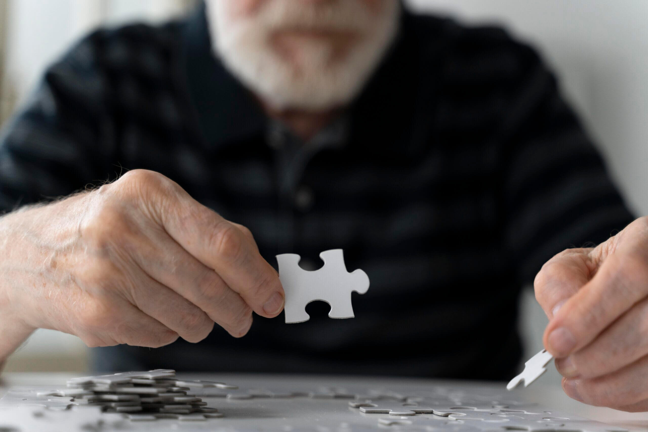 gentleman with Alzheimers doing a puzzle